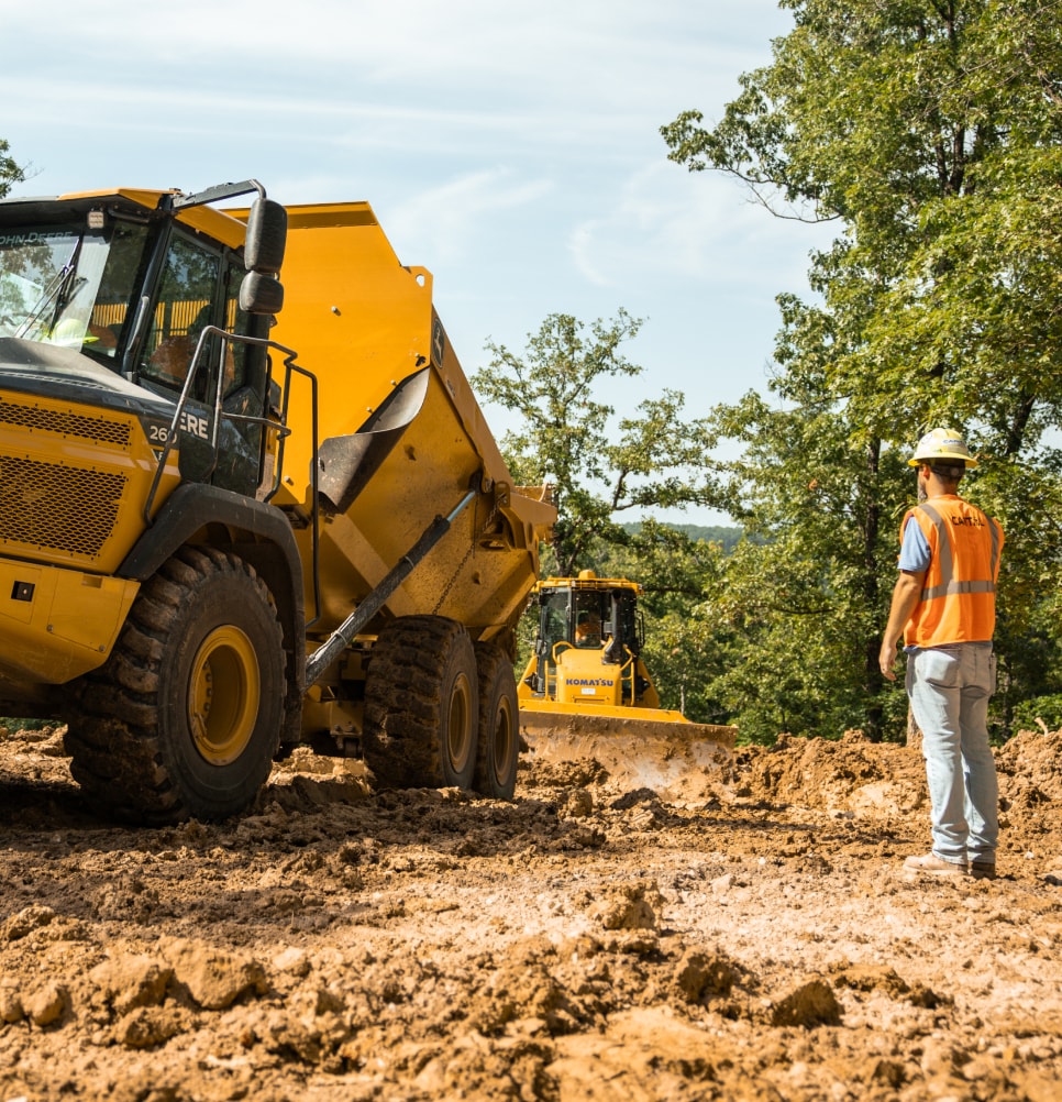 Capital worker observing dozer during earthwork project