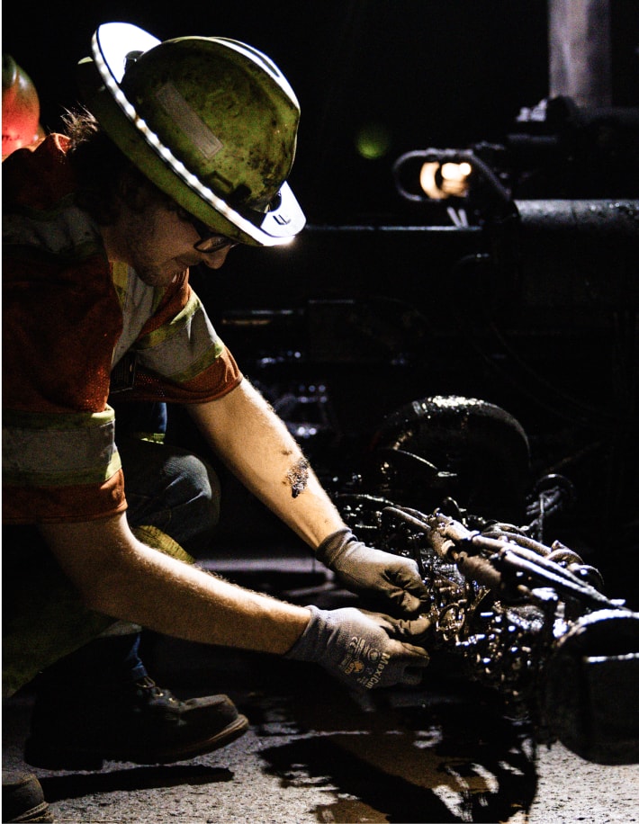 Capital equipment mechanic working on an engine part