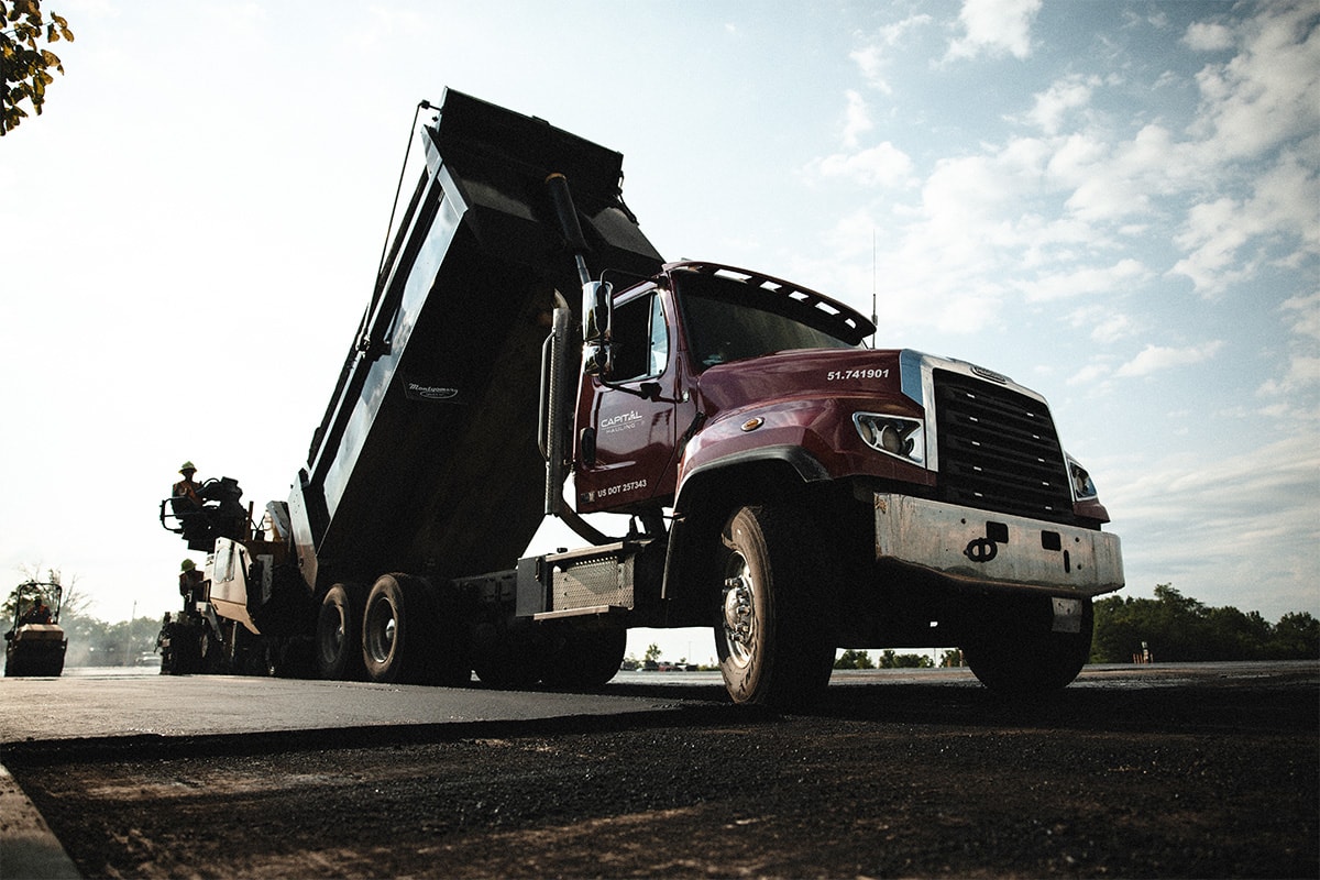 Capital asphalt haul truck during road construction project