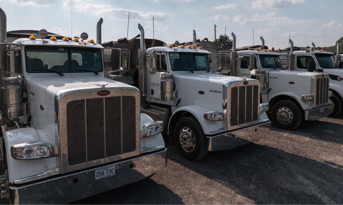 Row of Capital haul trucks