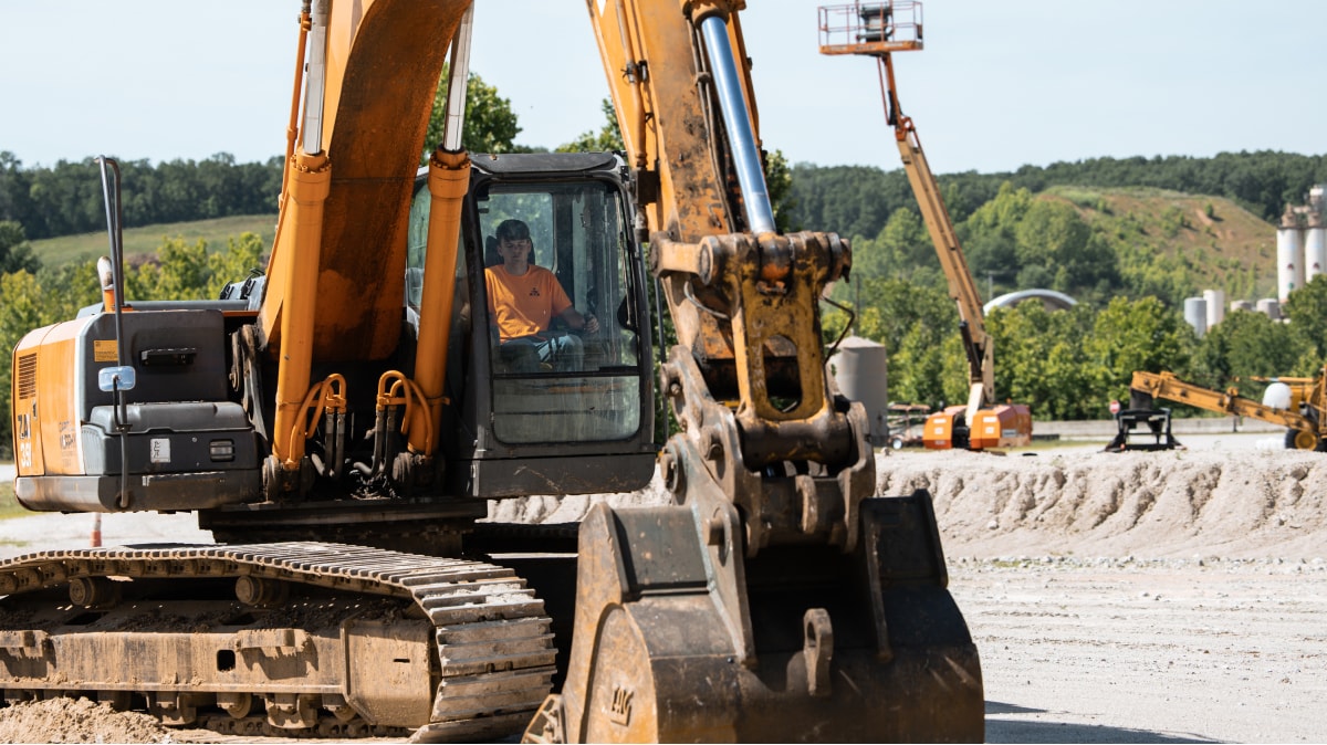 Capital Academy student in the cabin of an excavator